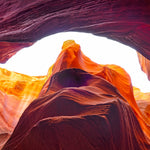 Shelter – fine art photograph looking up through an arch of orange and plum sandstone inside a slot canyon in northern Arizona, by Aaron Chang