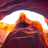 Shelter – fine art photograph looking up through an arch of orange and plum sandstone inside a slot canyon in northern Arizona, by Aaron Chang