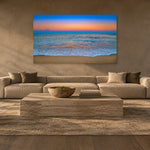 Pastel Beach by Aaron Chang over a long sofa in a plaster living room