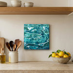 Sea Swirls 12" x 12" wall art in a travertine kitchen
